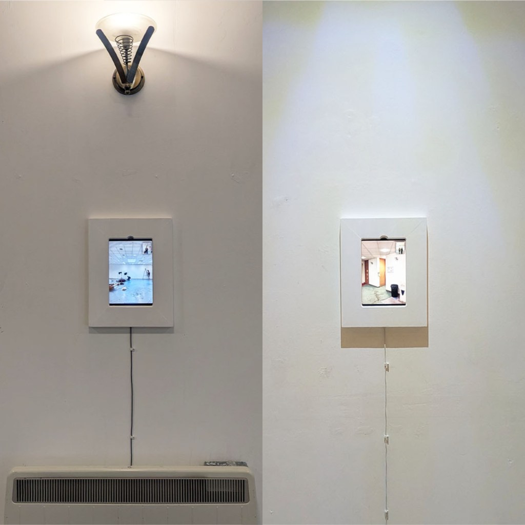 A wall-mounted display featuring two digital screens, one showing an interior scene of a spacious room and the other displaying a view of a pool area, both framed in white.