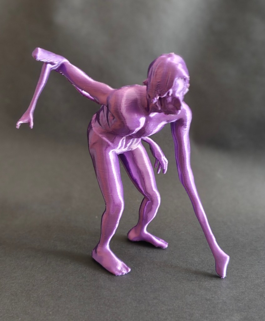 A purple 3D-printed figure of a human-like form in a dynamic pose, with one arm extended and the other arm reaching downwards.