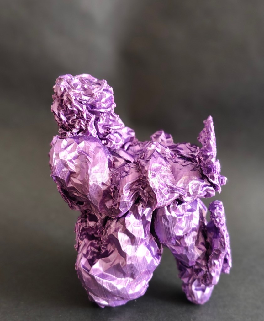 A crumpled purple sculpture resembling a figure, set against a dark background.